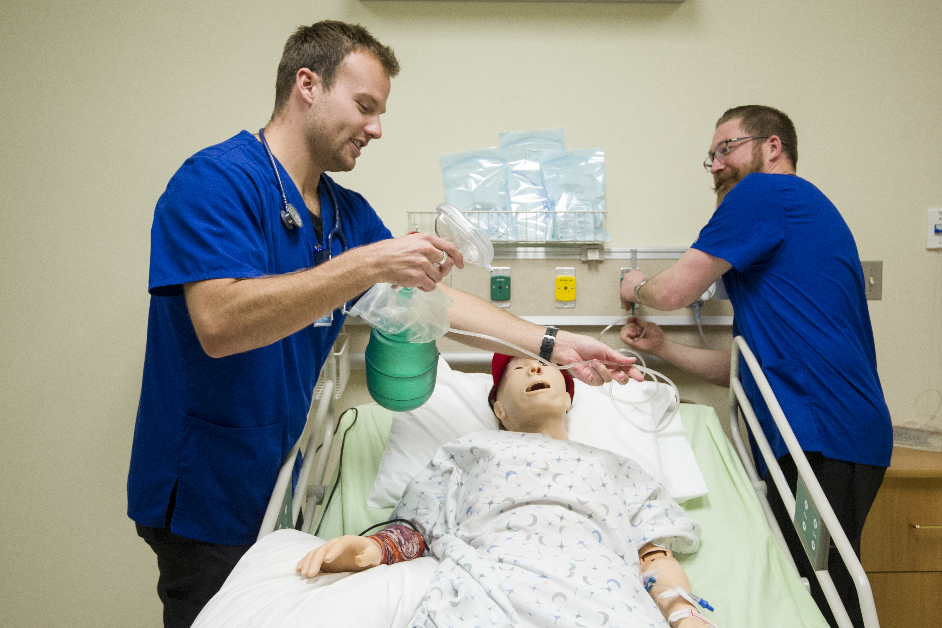 Students actively working with a high fidelity manikin in the simulation lab