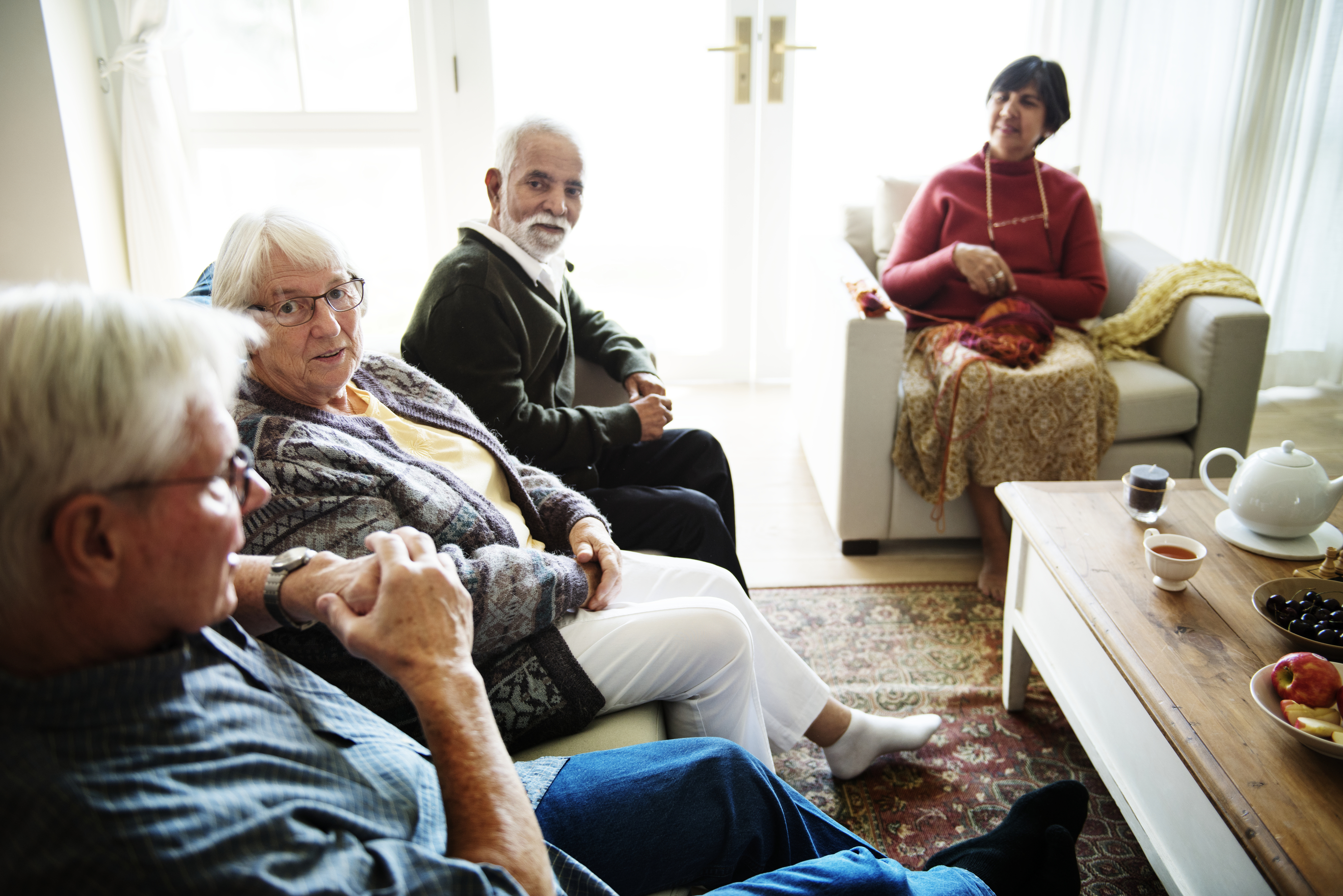 Seniors chatting in living room