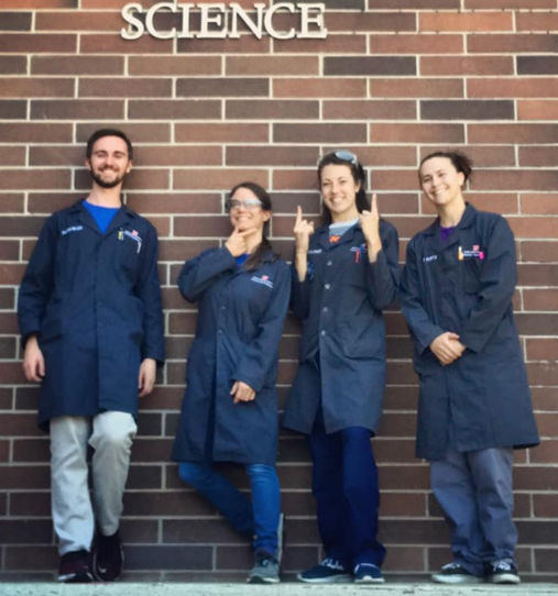 Group of 4 stockroom student employees outside of the science building
