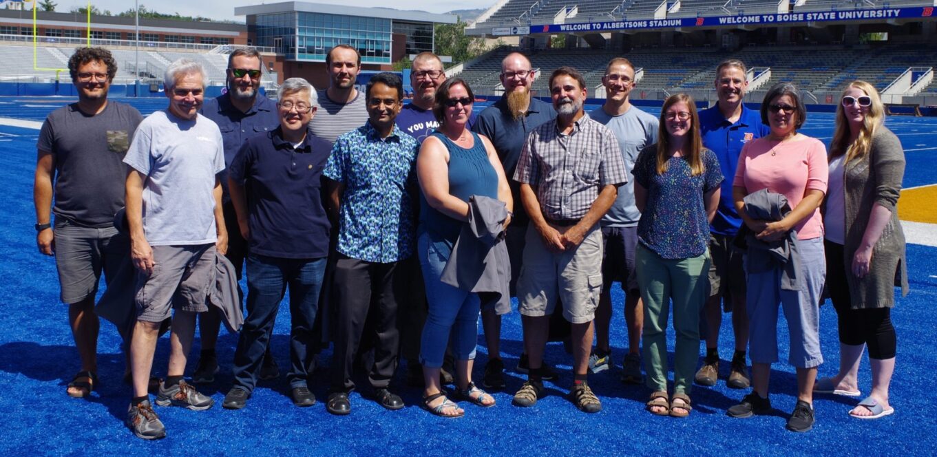 Group photo of the faculty of the Department of Chemistry and Biochemistry on the blue field at Albertsons Stadium