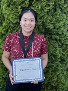 Photo of Jasmine Baclig holding her certificate for INBRE 1st place Faculty Choice award