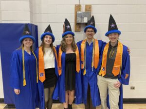 Katie Devereaux, Ally Bonnifield, Kenzie Ballinger, Gabe Miles and Seamus Jude (from left to right) in their graduation gowns and wizard hats