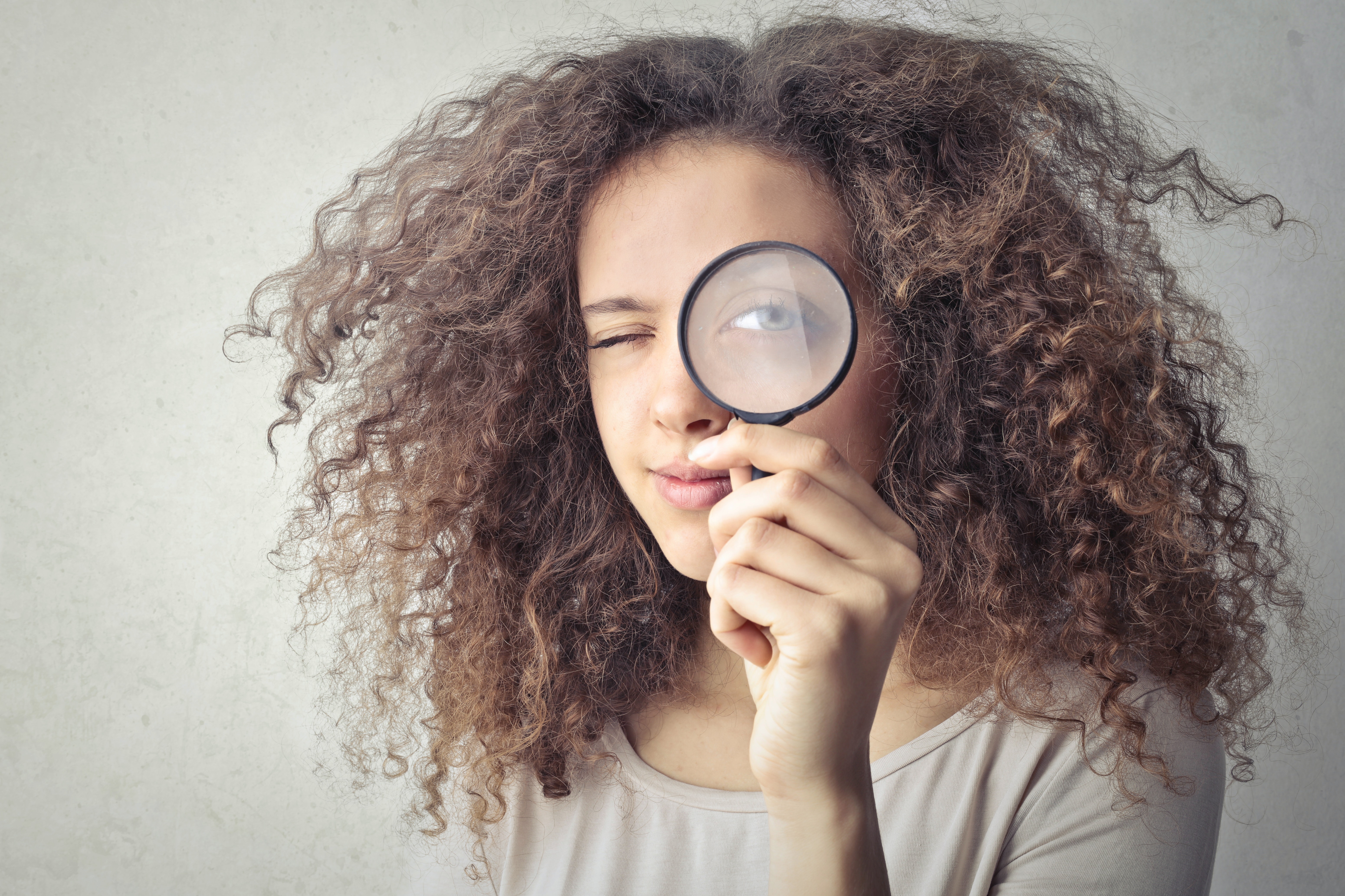 Photo of Woman with Magnifying Glass