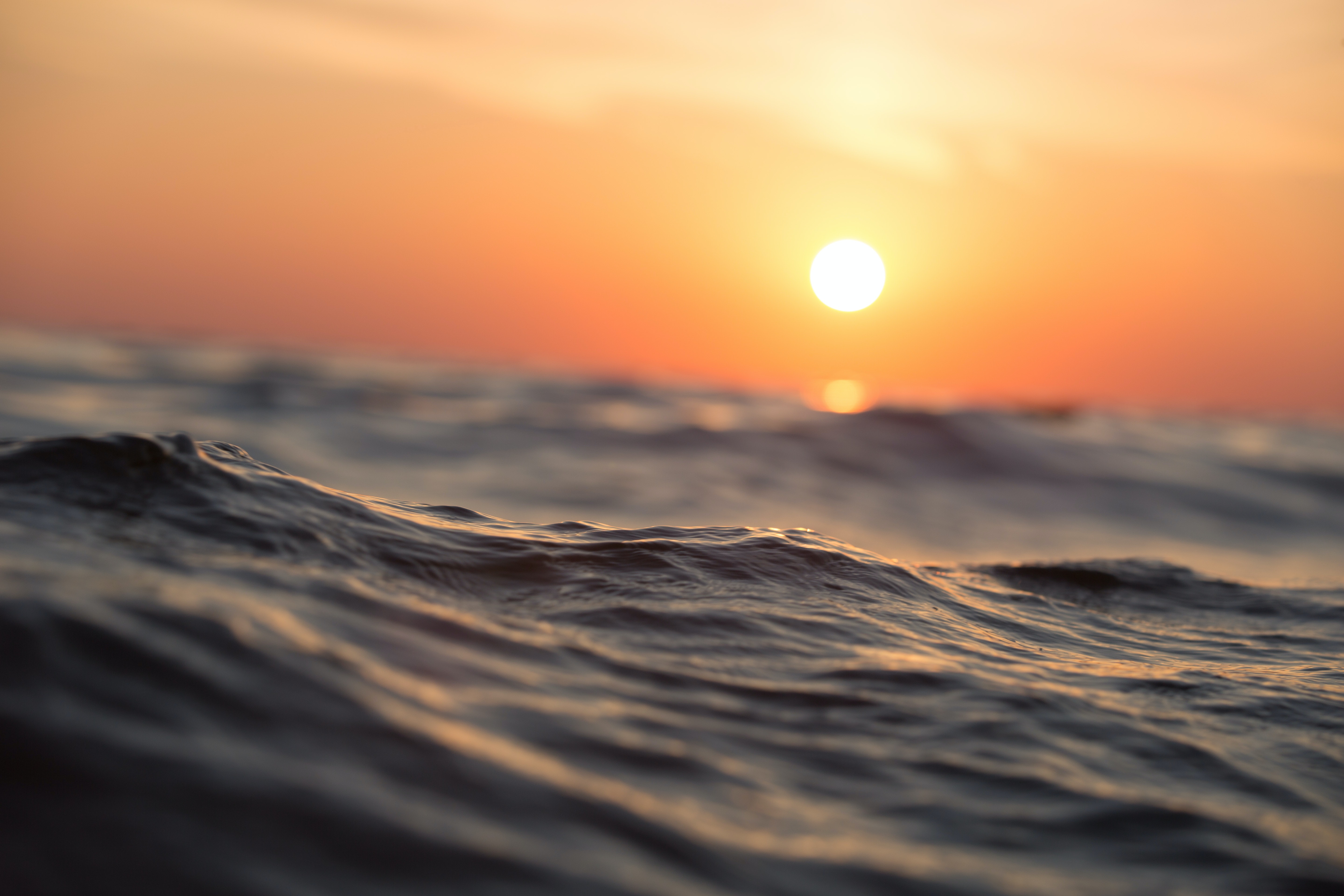 Photo of ocean waves and sunset