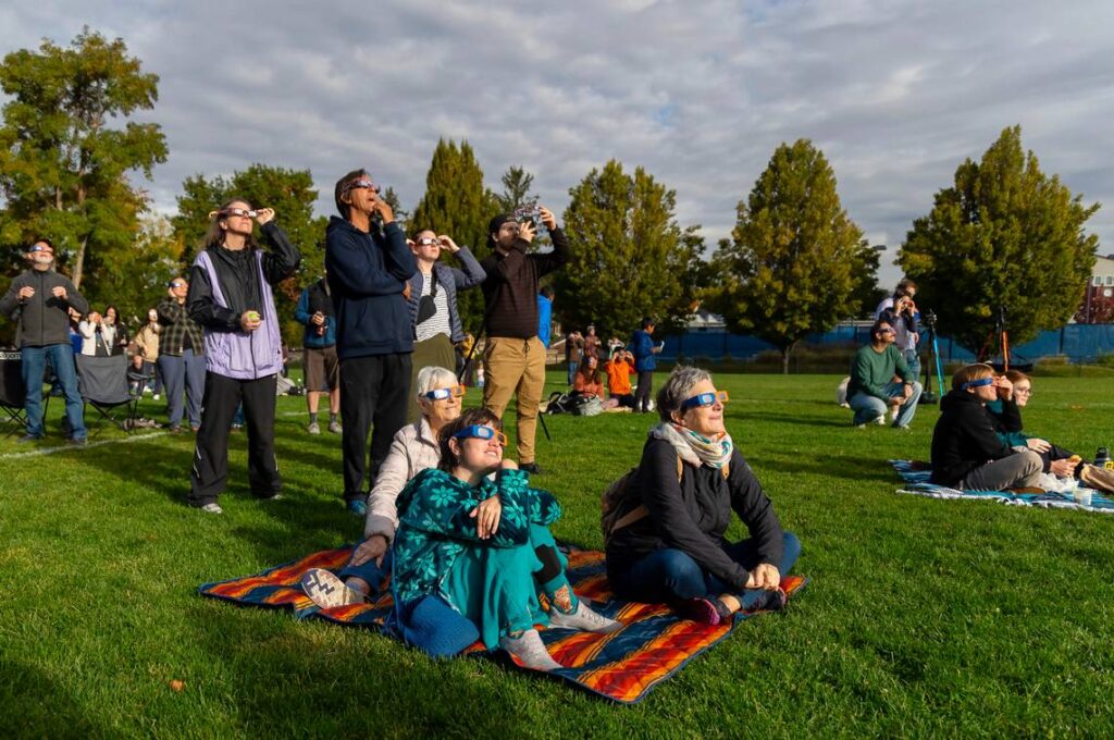 A group of people watching the solar eclipse.