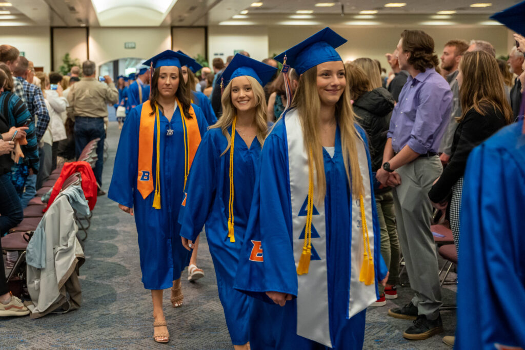 BSN graduates smile as they walk in for the processional.