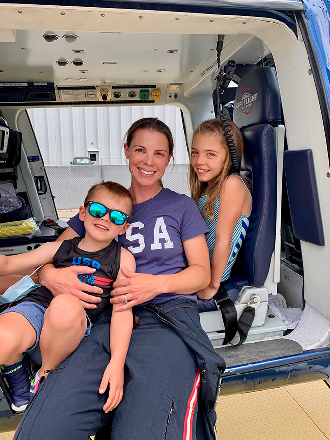 Jamie Hutt sits with her two kids in a helicopter.