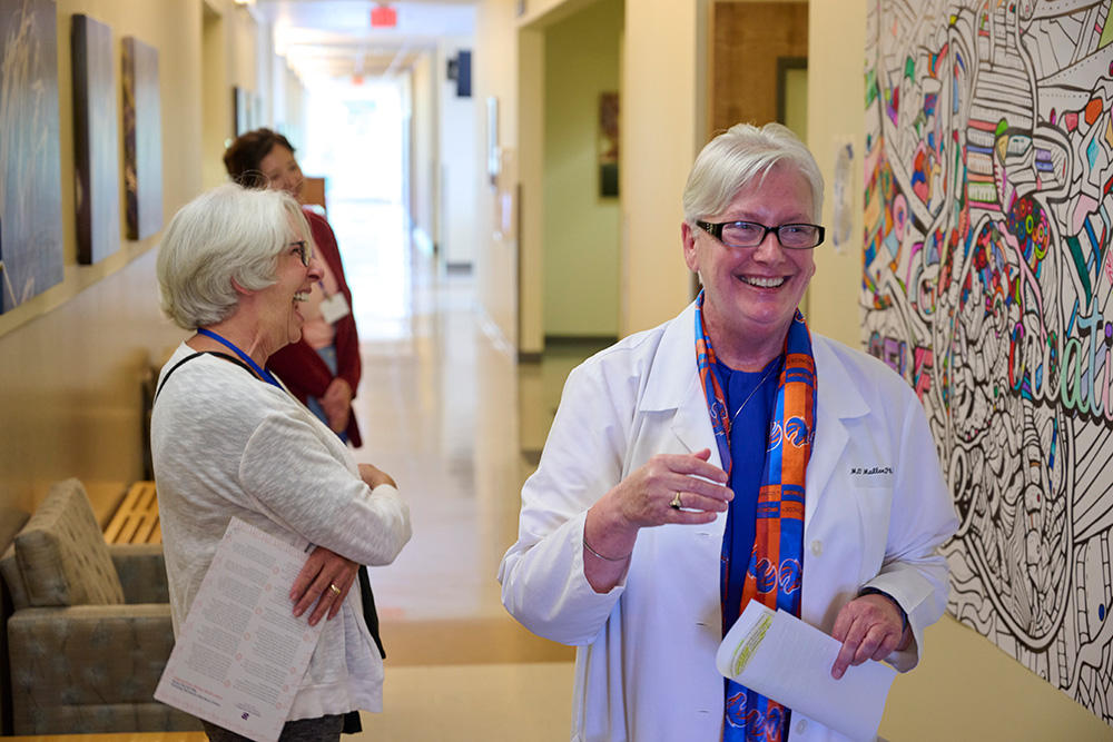 OMallon laughs with guests outside the self-care room at the school of nursing.