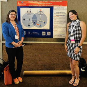 Sarah Llewellyn and Nicolette Misbrenner pose with their research poster