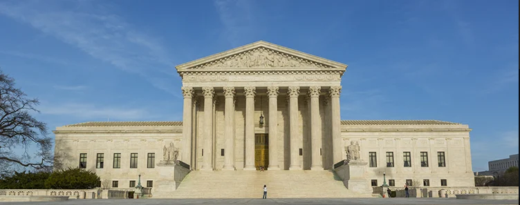 Panoramic view of the front of the US Supreme Court Building on a sunny day