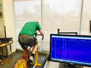 Client ride stationary bike while attached to monitor