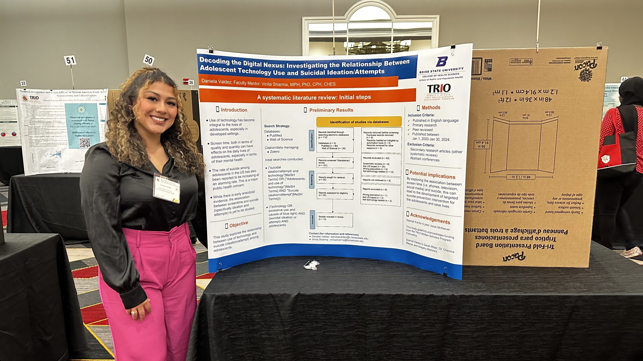 Woman standing near a table presenting research